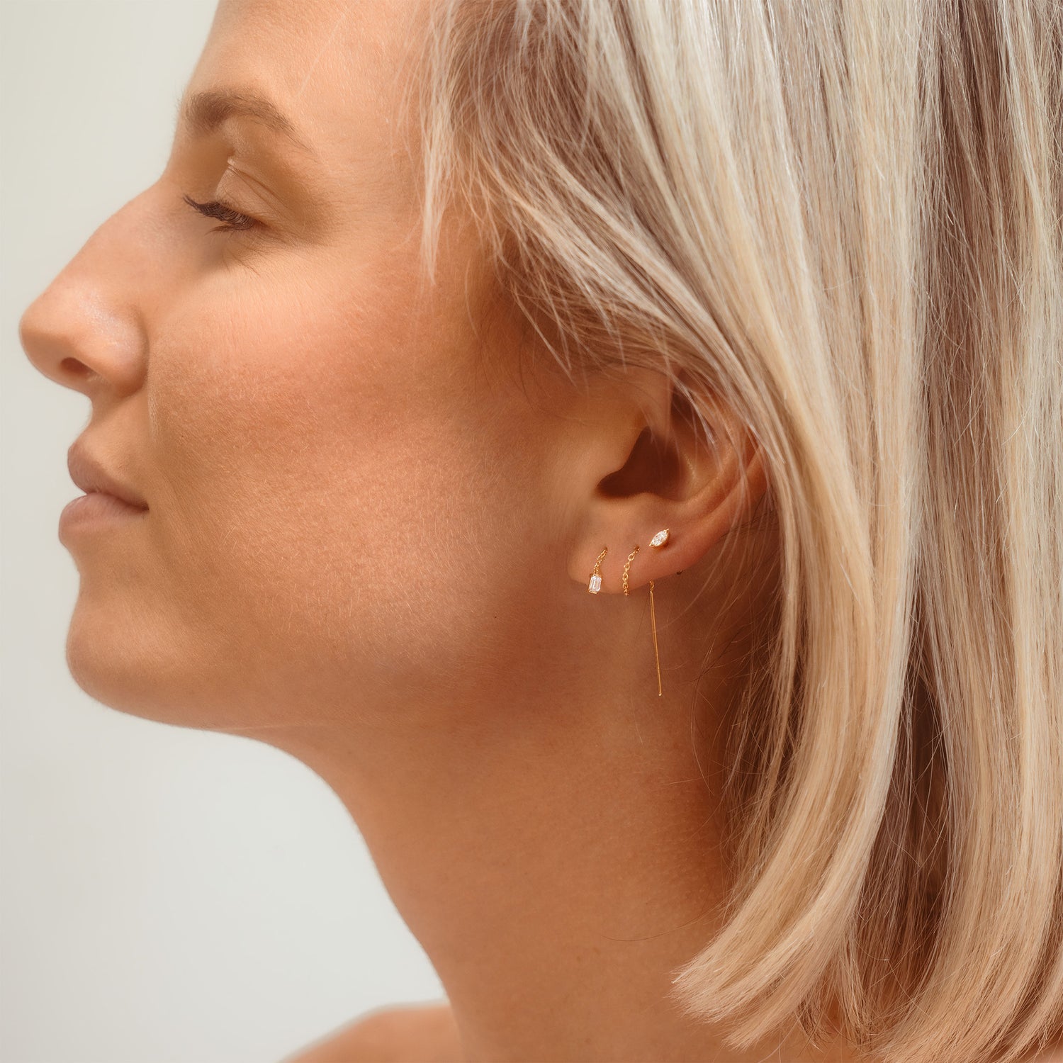 diamond and chain earrings on model