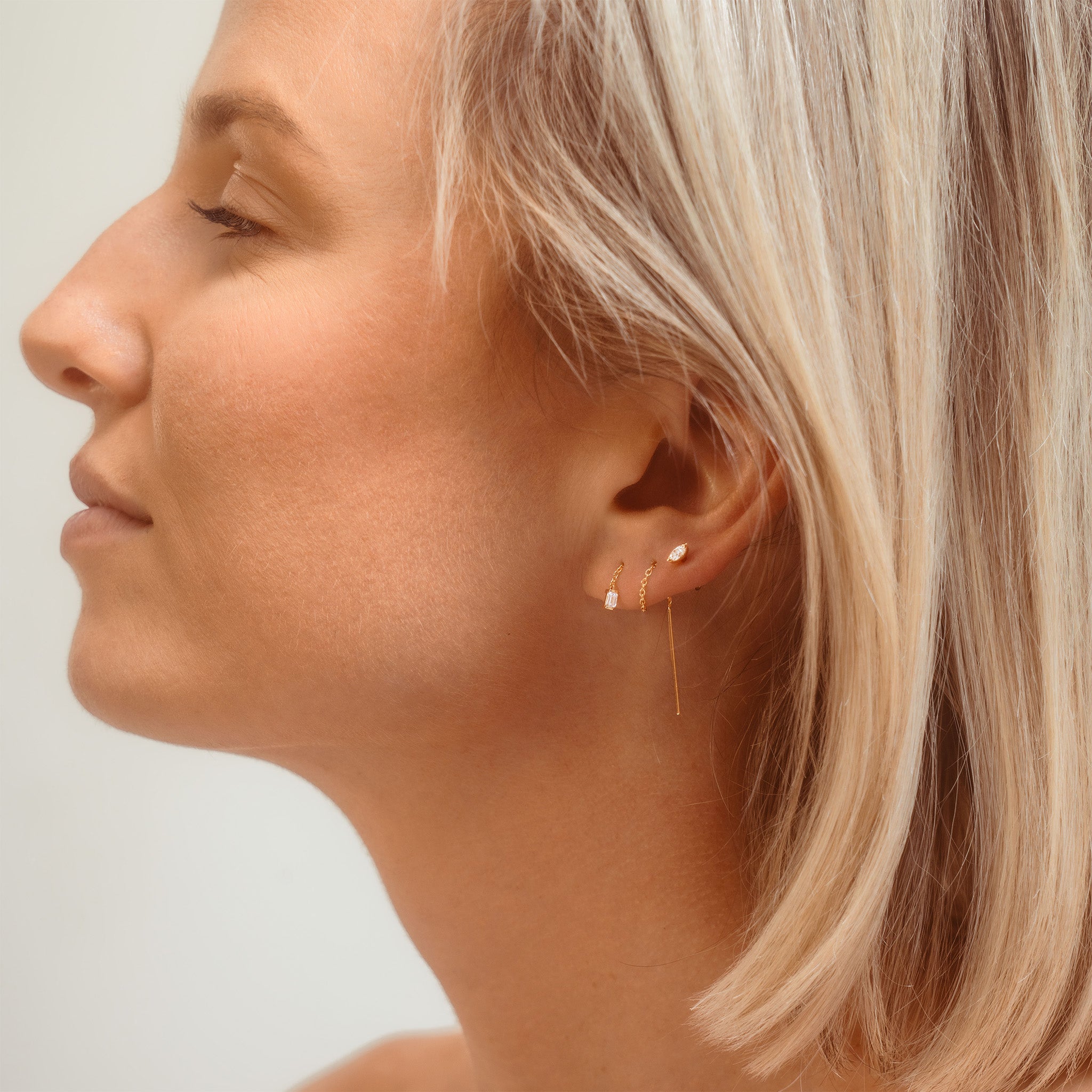 diamond and chain earrings on model