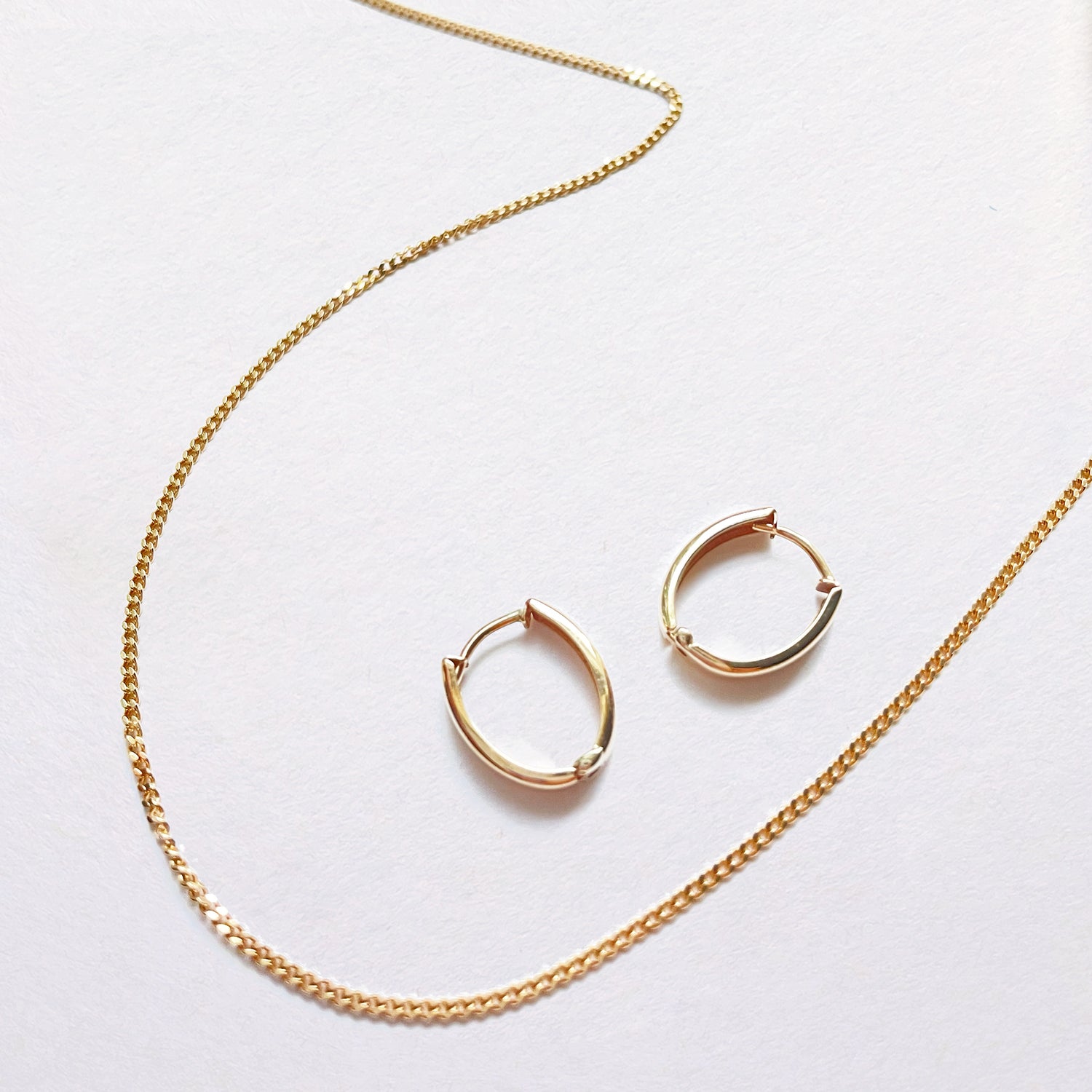 solid gold huggie hoop earrings and embrace curb chain necklace - AïANA jewellery Australia