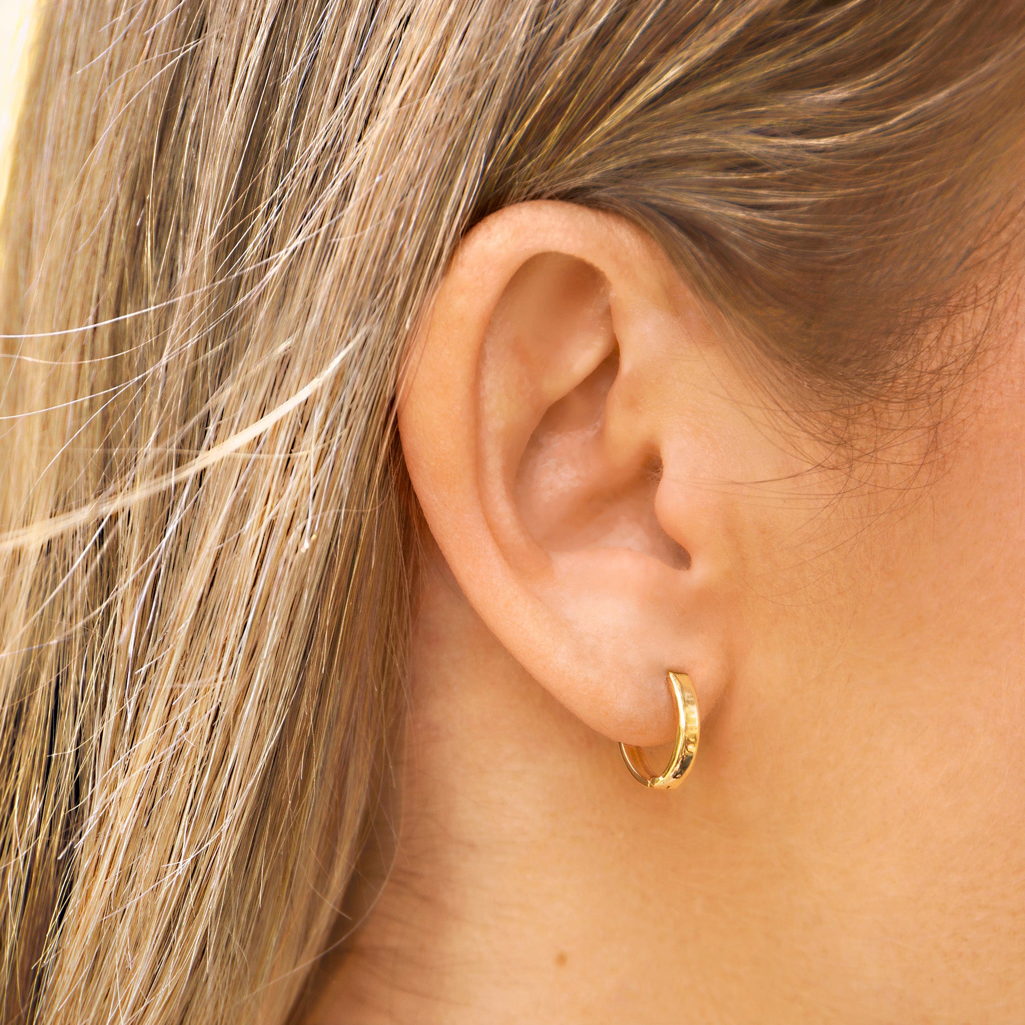 Solid Yellow Gold huggie hoop earrings on ear- AïANA jewellery Australia