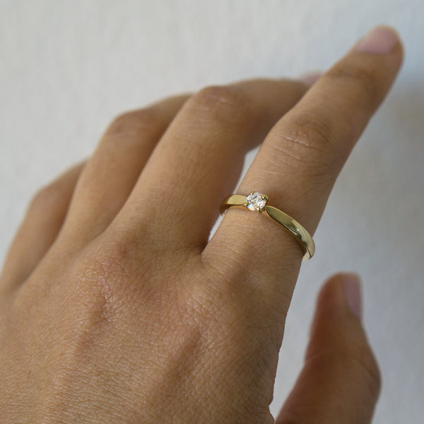 Yellow gold single diamond ring on finger - AïANA