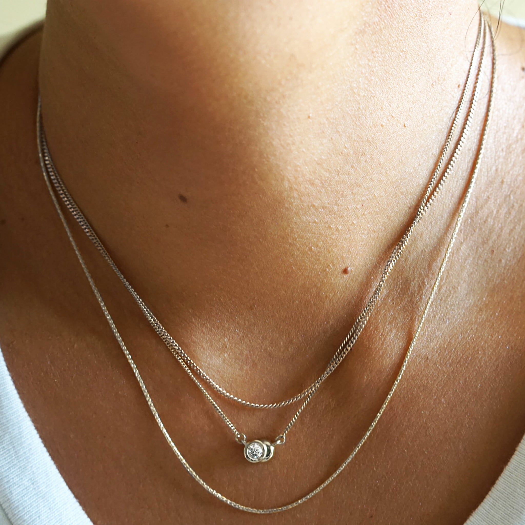 Layered white gold necklaces by AïANA