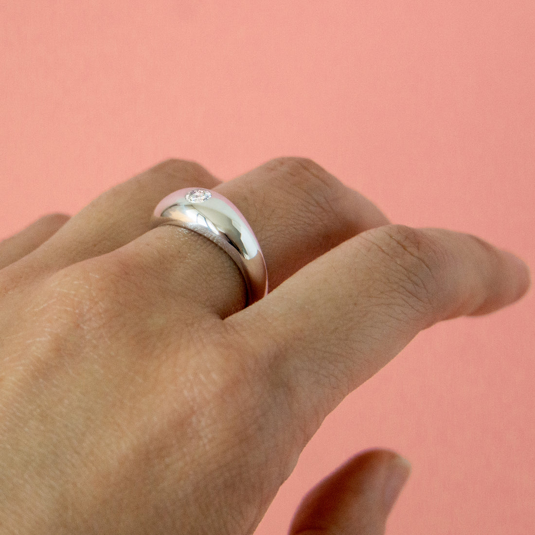 Thick solid gold diamond ring on finger - AïANA