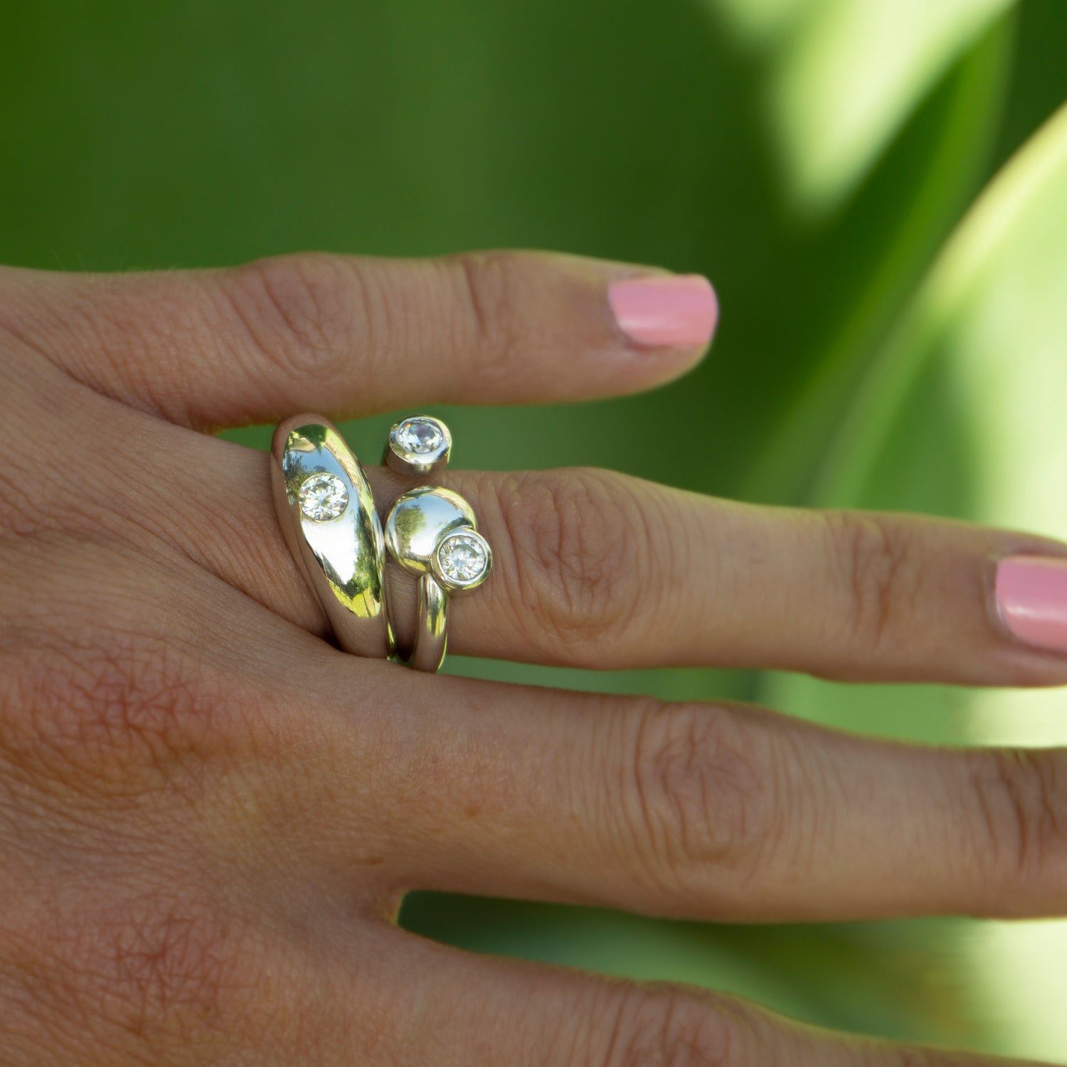 Two solid gold diamond rings stacked on finger - AïANA