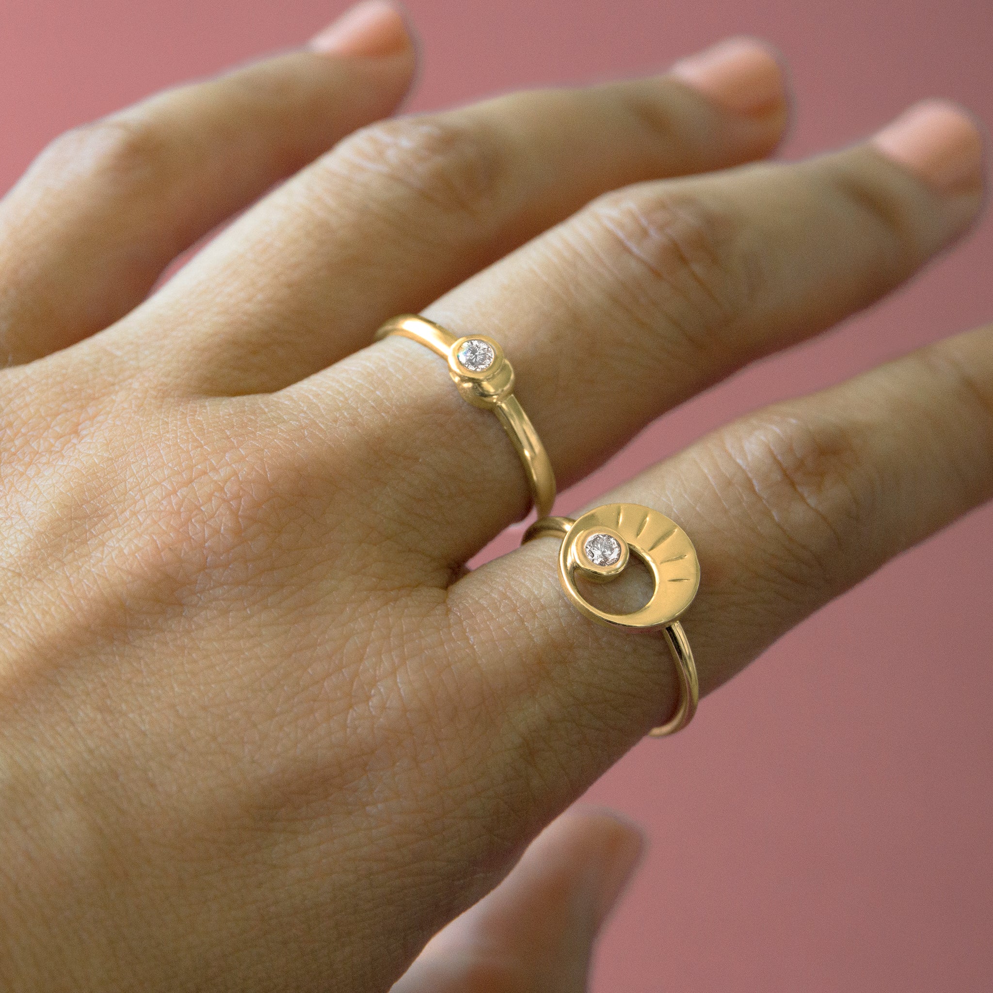 two gold and diamond statement rings on hand